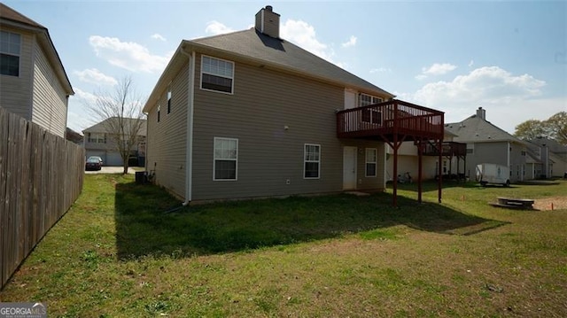 back of house with a yard and a deck