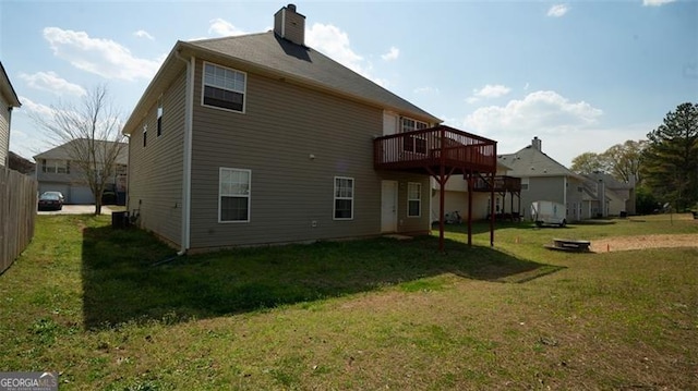 back of property featuring a lawn and a deck