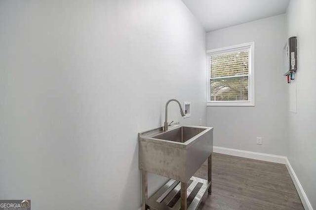 laundry area with dark hardwood / wood-style flooring, washer hookup, and sink