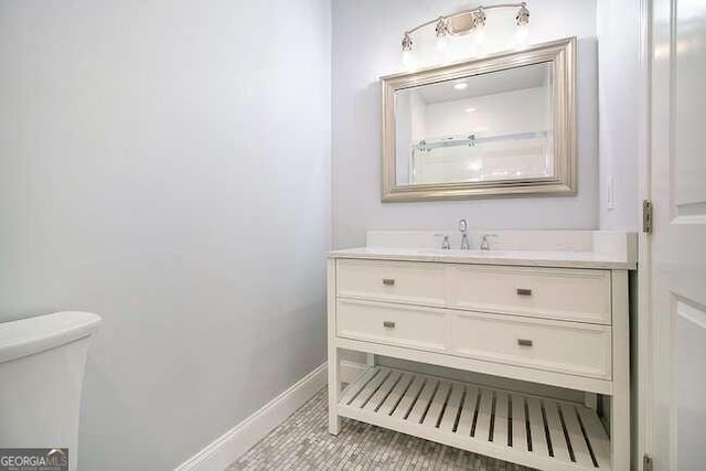 bathroom with tile patterned floors, vanity, and toilet