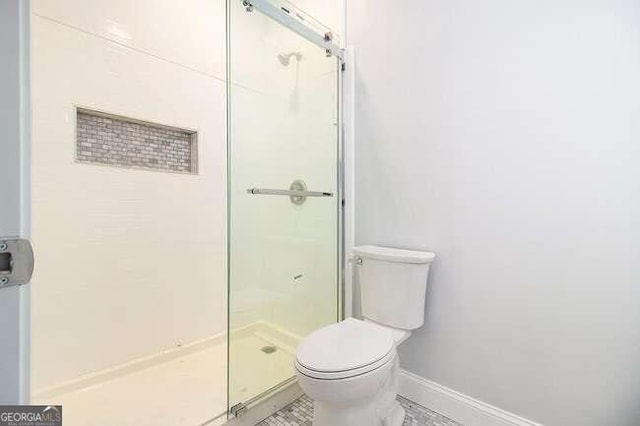 bathroom featuring a shower and toilet