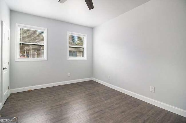 spare room with ceiling fan and dark wood-type flooring