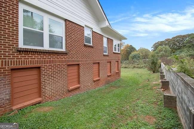 view of side of home featuring a yard