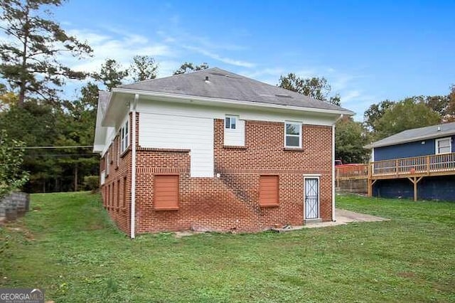 back of house with a lawn