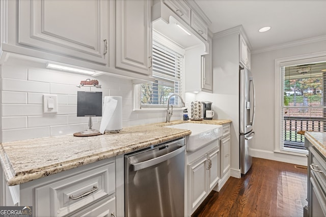 kitchen featuring crown molding, white cabinets, dark hardwood / wood-style floors, and appliances with stainless steel finishes