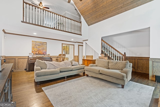 living room featuring dark hardwood / wood-style flooring, high vaulted ceiling, ceiling fan, and wooden ceiling