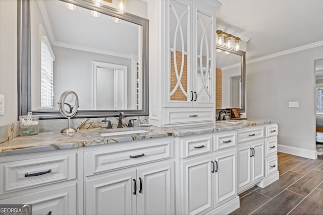 bathroom with vanity, wood-type flooring, and ornamental molding