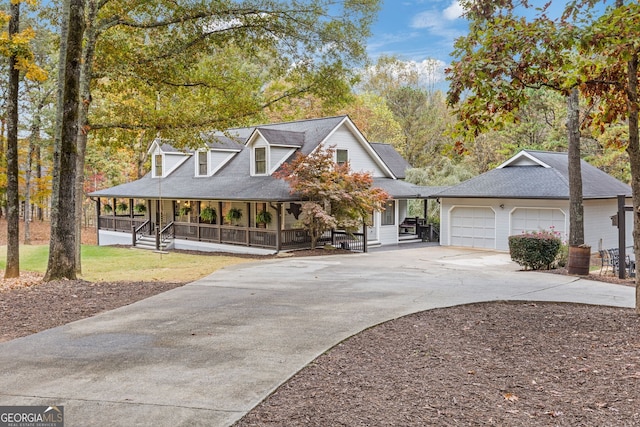 view of front of property featuring a sunroom, a porch, and a garage