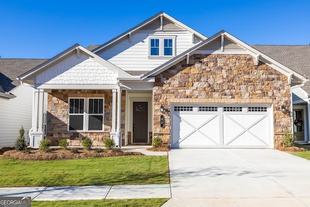 craftsman inspired home featuring a garage and a front lawn