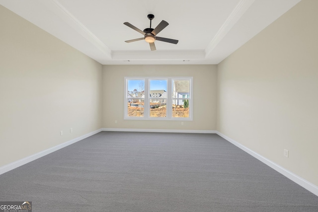 empty room featuring a tray ceiling, ceiling fan, and crown molding