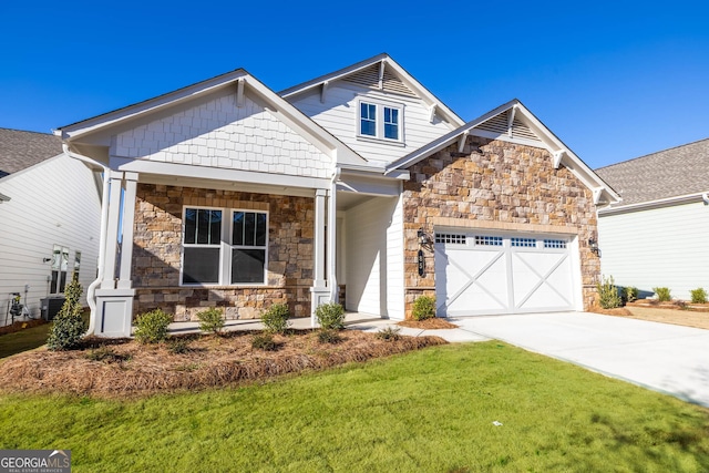 craftsman-style house with a front yard, central AC, and a garage