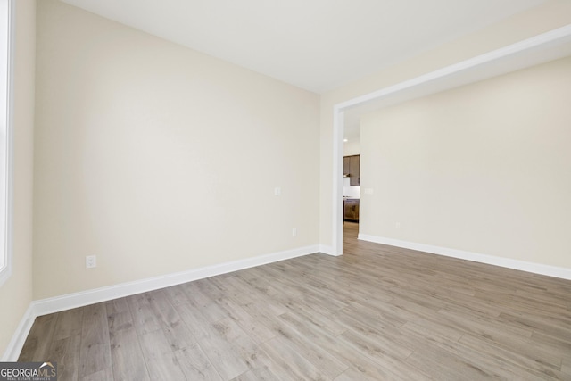 spare room with light hardwood / wood-style flooring