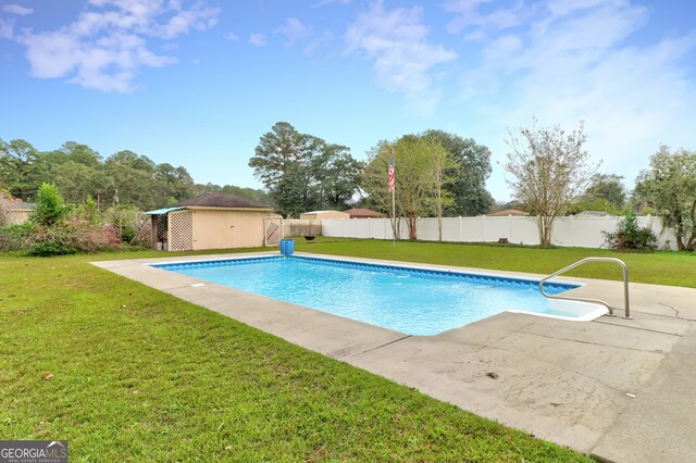 view of swimming pool featuring a lawn and a patio