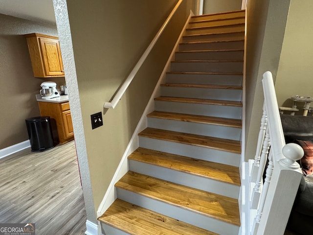 stairway featuring wood-type flooring