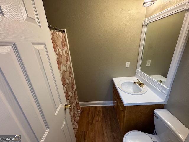 bathroom featuring hardwood / wood-style floors, vanity, and toilet