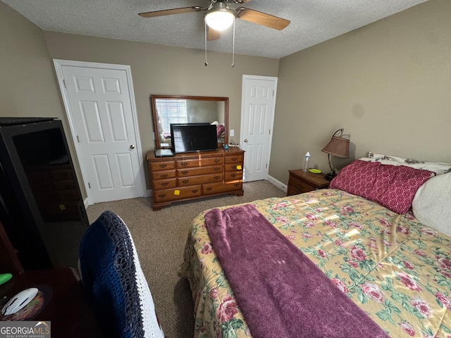 bedroom featuring ceiling fan, carpet, and a textured ceiling