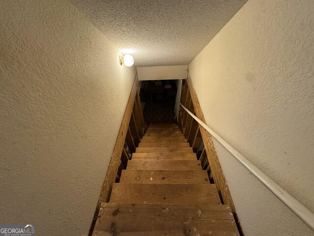 basement featuring wooden walls