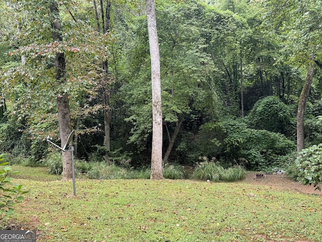 view of yard featuring a forest view
