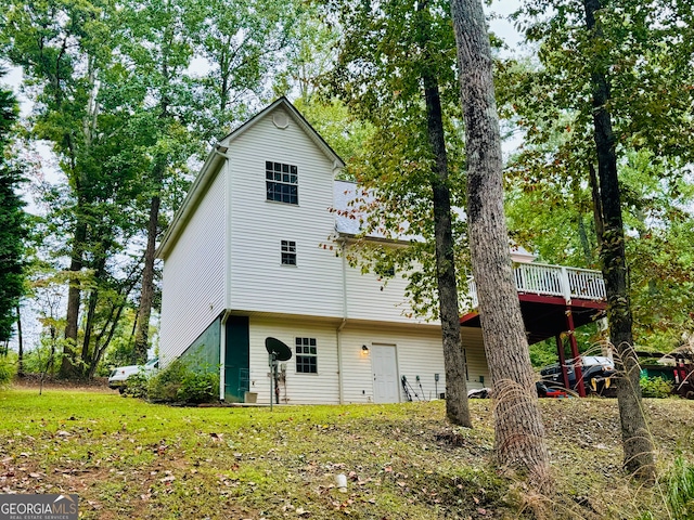 rear view of property featuring a deck