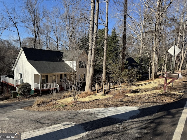 view of front facade with a porch and a shingled roof