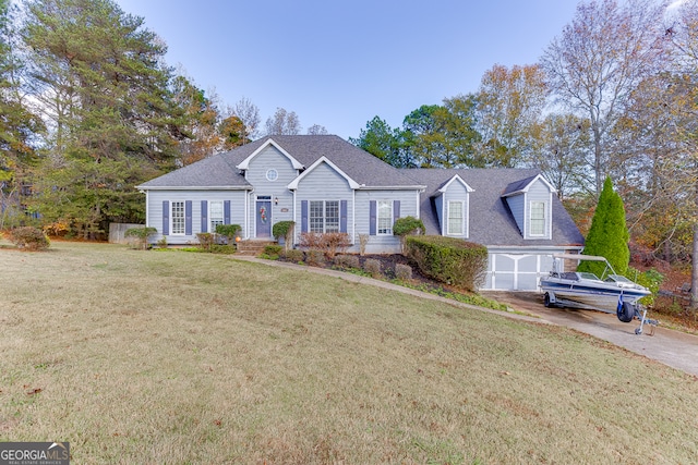 view of front of property with a front yard and a garage