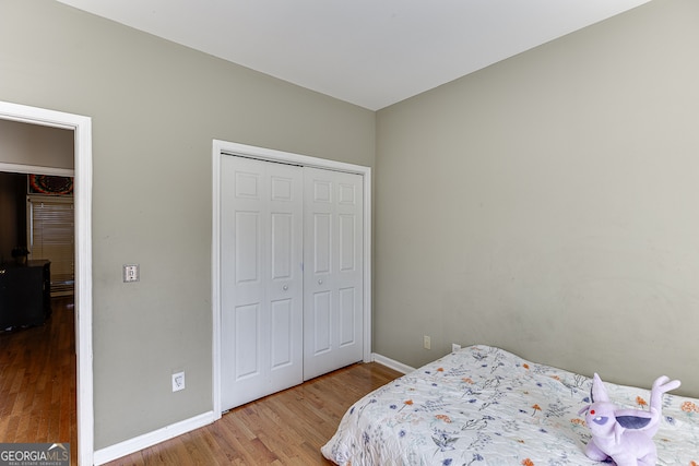 bedroom with a closet and hardwood / wood-style floors