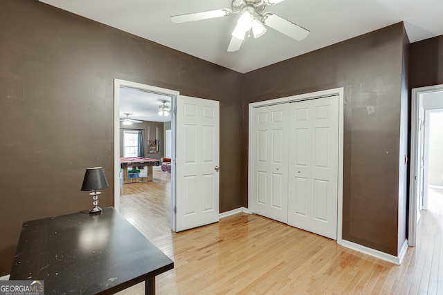 unfurnished bedroom featuring light wood-type flooring, a closet, and ceiling fan