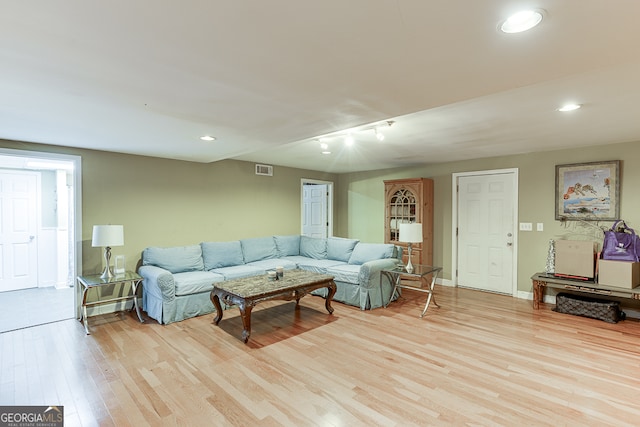 living room featuring light hardwood / wood-style floors and rail lighting