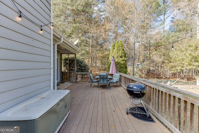 wooden deck with a grill