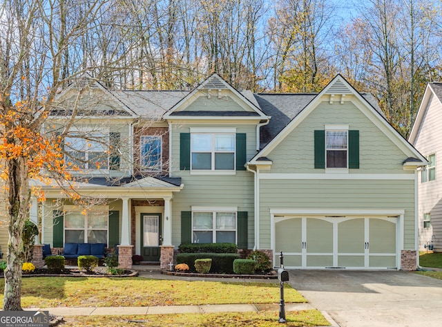 view of front of property featuring a front lawn and a garage