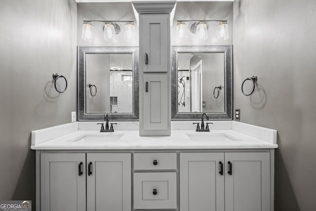 bathroom featuring a sink and double vanity