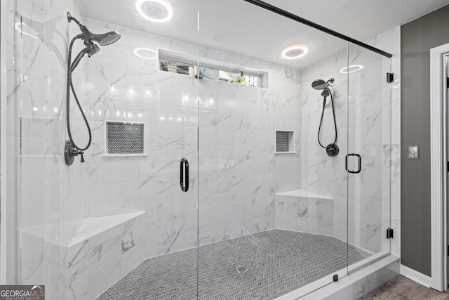 bathroom featuring a marble finish shower and visible vents