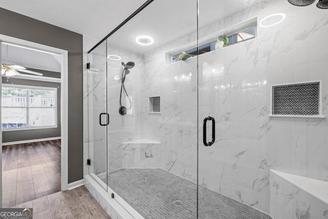 bathroom with wood tiled floor, a marble finish shower, and ceiling fan