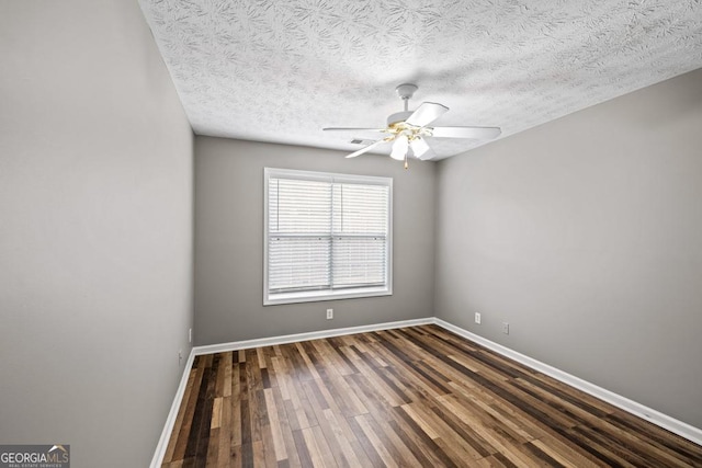 unfurnished room featuring a ceiling fan, a textured ceiling, baseboards, and wood finished floors