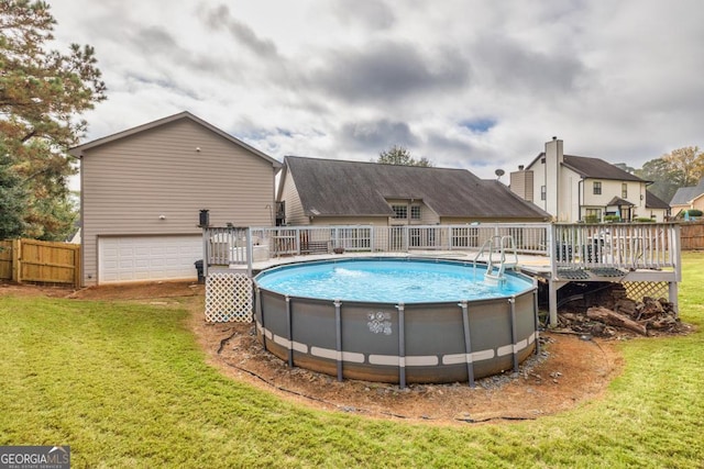 view of swimming pool featuring a yard, a wooden deck, a fenced in pool, and fence