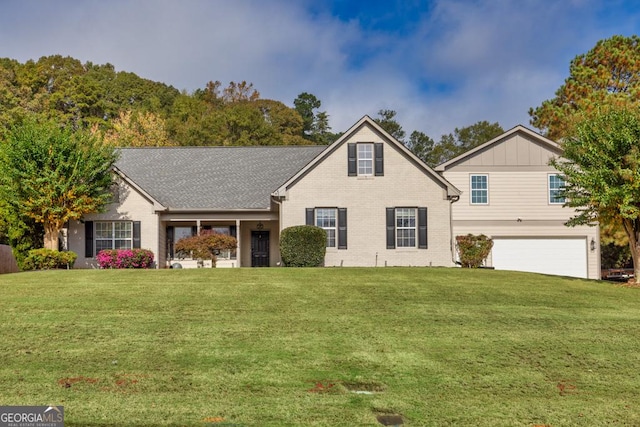 traditional home with an attached garage, a front lawn, board and batten siding, and brick siding