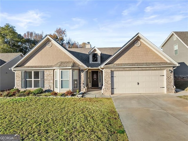 view of front of house with a front lawn and a garage