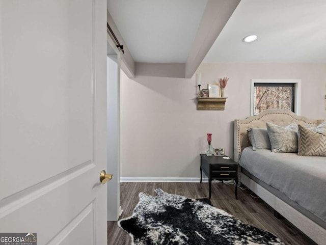 bedroom with dark hardwood / wood-style floors