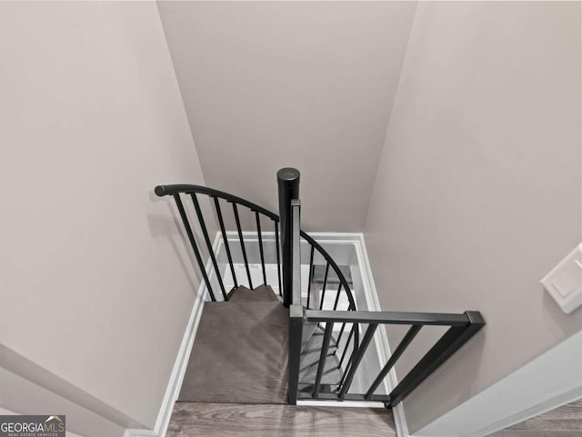 stairs with hardwood / wood-style floors