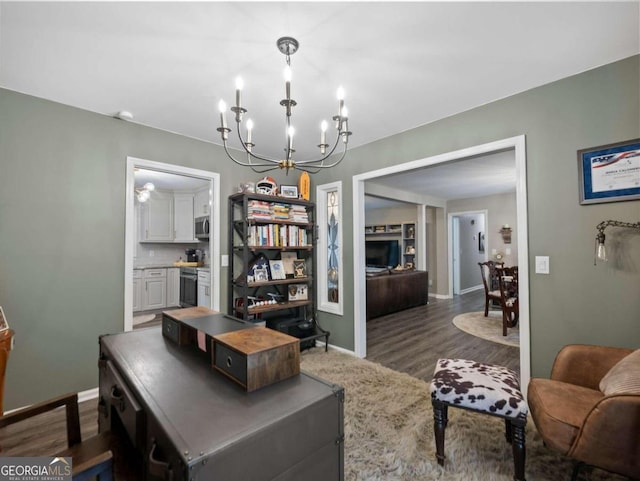 office with dark hardwood / wood-style floors and an inviting chandelier