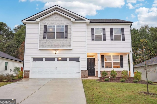 view of front of home with a front yard and a garage