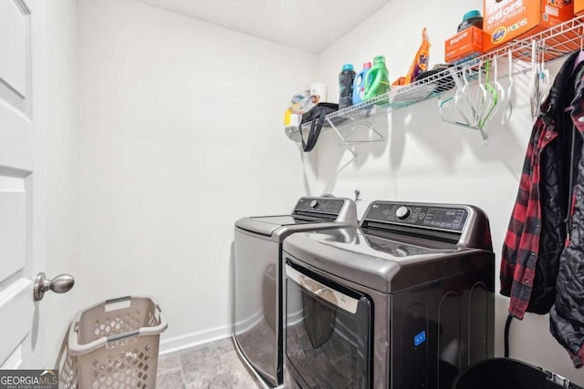 laundry area with washer and dryer and light hardwood / wood-style floors