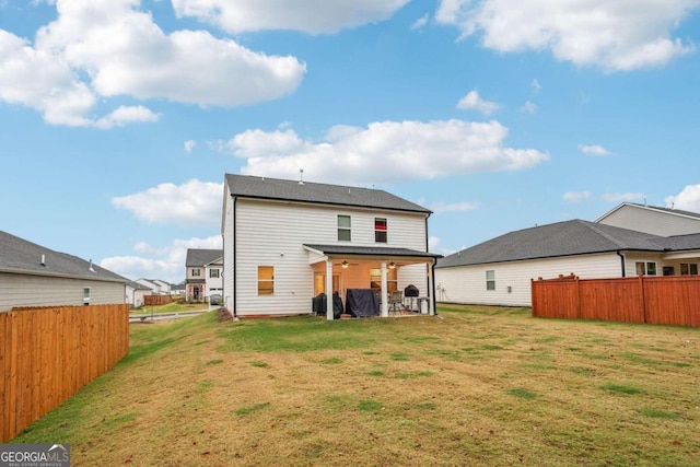 back of house with a yard