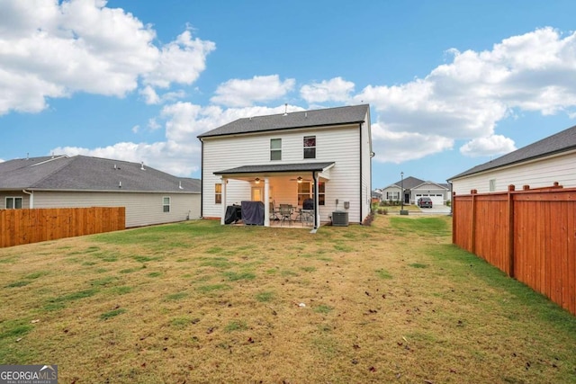 back of house featuring a yard, a patio, and central air condition unit