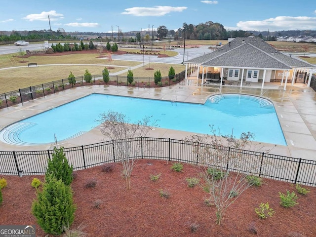 view of pool featuring a patio area and a yard