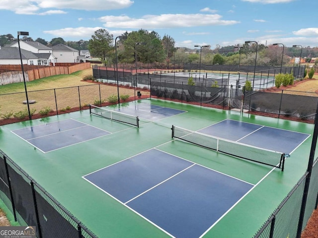 view of tennis court featuring basketball hoop