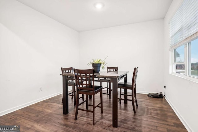 dining space with dark hardwood / wood-style flooring