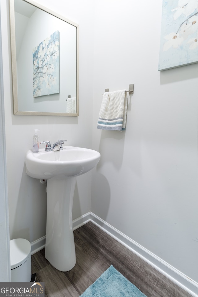 bathroom with wood-type flooring