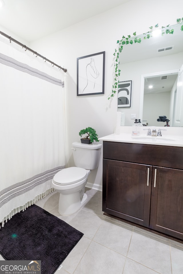 bathroom with tile patterned floors, vanity, and toilet