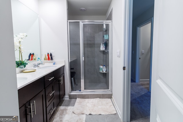 bathroom with tile patterned flooring, vanity, and an enclosed shower